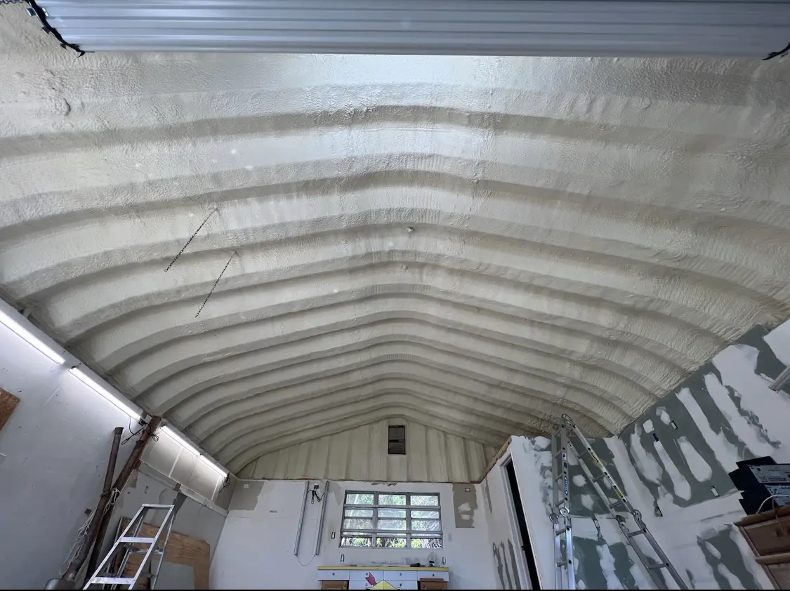 Spray polyurethane foam applied to the underside of a metal roof deck in Maplewood